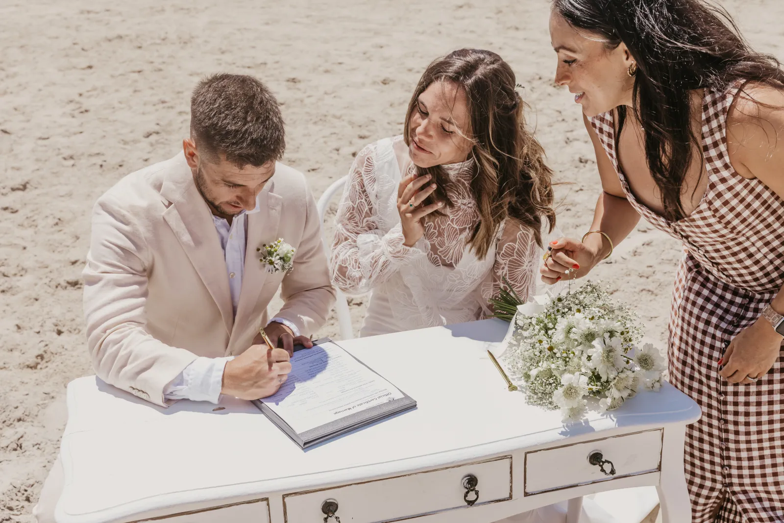 Ellie officiating a wedding ceremony, mid-vows, with the wedding party gathered